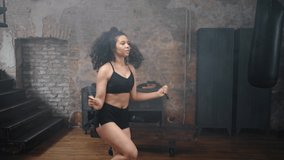 Young female athlete with kinky hair practices cardio jump rope workout in gym. African American woman prepares for intensive boxing training - Powered by Shutterstock - Get 15% off with code: PIKWIZARD15