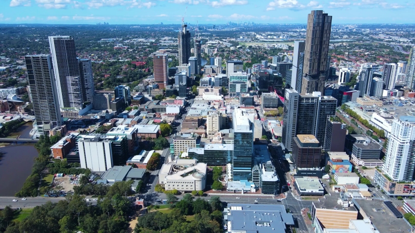 Aerial drone pullback view of Parramatta CBD in Greater Western Sydney, NSW, Australia showing Parramatta River and development of the city  Royalty-Free Stock Footage #1089289455
