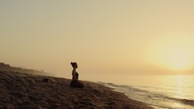 Focused woman practicing meditation on sandy beach summer evening. Yoga woman sitting lotus position near ocean waves. Attractive sportswoman making relaxing asana outdoors. Self care concept. - Powered by Shutterstock - Get 15% off with code: PIKWIZARD15