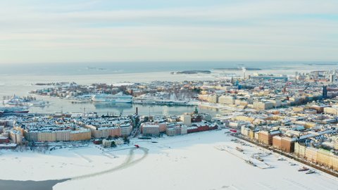 Aerial view Helsinki Finland. Urban cityscape on the shores of the Baltic Sea in winter with frozen sea and old architecture, churches and houses.
