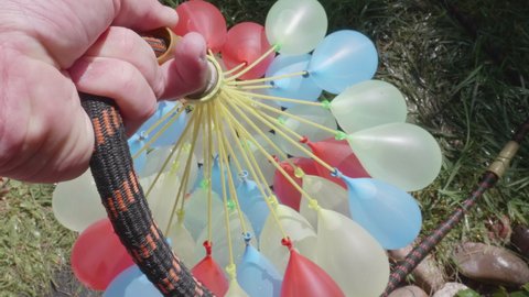 This is a video of someone making a bunch of water balloons at once with a handy tool. Shot on a GH5