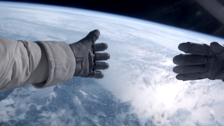 POV First person view through helmet during the spacewalk - astronaut trying to catch something in space Royalty-Free Stock Footage #1089293233