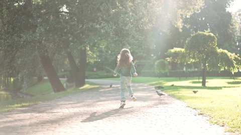 Back View Cheerful Little Girl Running Stock Footage Video (100% ...