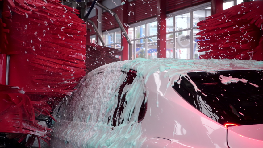 White car moving though automatic car wash machine. Brush moving to clean the car. Slow motion shot | Shutterstock HD Video #1089294073