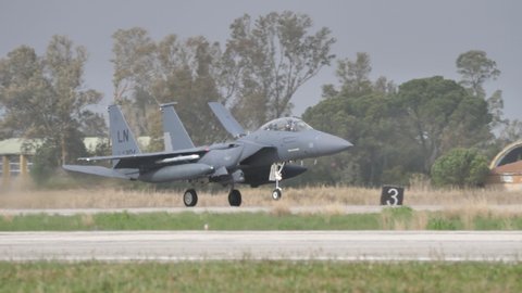 Andravida Greece APRIL, 1, 2022 Fighter jet airplane lands with dorsal air brake opened after NATO exercise mission. McDonnell Douglas Boeing F-15 Strike Eagle of United States Air Force USAF