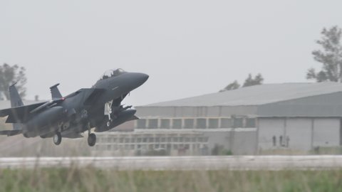 Andravida Greece APRIL, 1, 2022 Military supersonic fighter plane retract landing gear after take off. McDonnell Douglas F-15 Strike Eagle multirole fighter jet of United States Air Force USAF