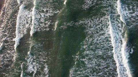 Drone view of stormy waves forming in the sea due to the wind. Wave foam caused by the pace of the sea waves. 4K Video