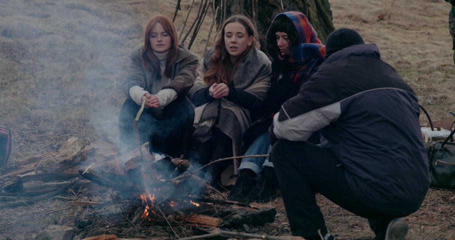 Refugees Around Bonfire During War Crisis.