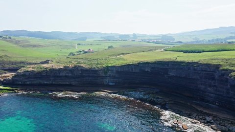Aerial drone Top Notch side view of El Bolao Cliff, in Cantabria, summer of Northern Spain.