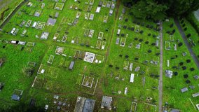 Tombstones on Church Island, Menai Strait, Anglesey. Wales in UK. Aerial ascendent directly above and circling
