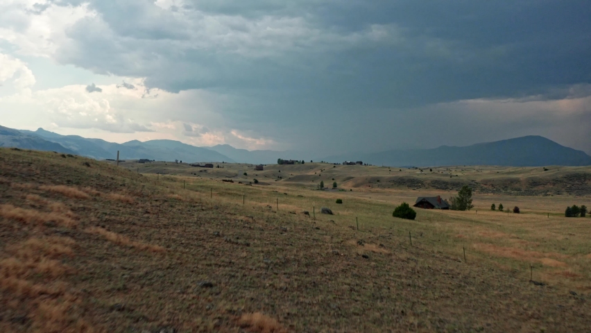 An onward moving aerial shot of the Paradise Valley of the Yellowstone River in southwestern Montana. The valley is flanked by the Absaroka Range on the east and the Gallatin Range on the west.