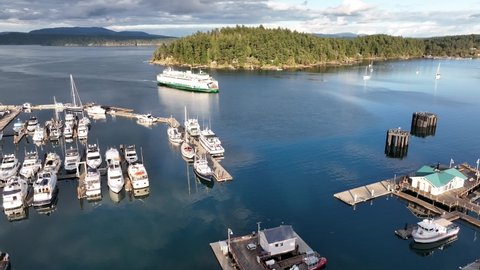 Cinematic 4K aerial drone footage of the Port and town of Friday Harbor with the arriving ferry, terminal, commercial zone, Brown Island in the San Juan Islands