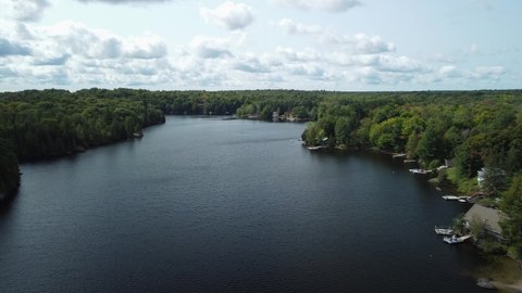 A row of cottages sit at the edge of a lake in the Muskoka region of Ontario