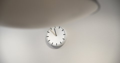White mechanical Wall Clock on white background. 12 hours. Second handes along the dial. Twelve oclock. The Clock With The Black Arrow Shows The Time Eight Hours. Time concept