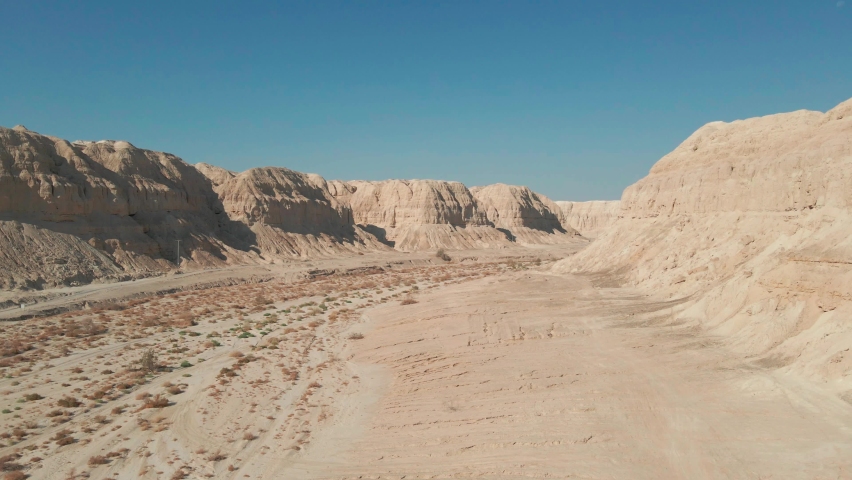 drone sails between mountain at judean desert