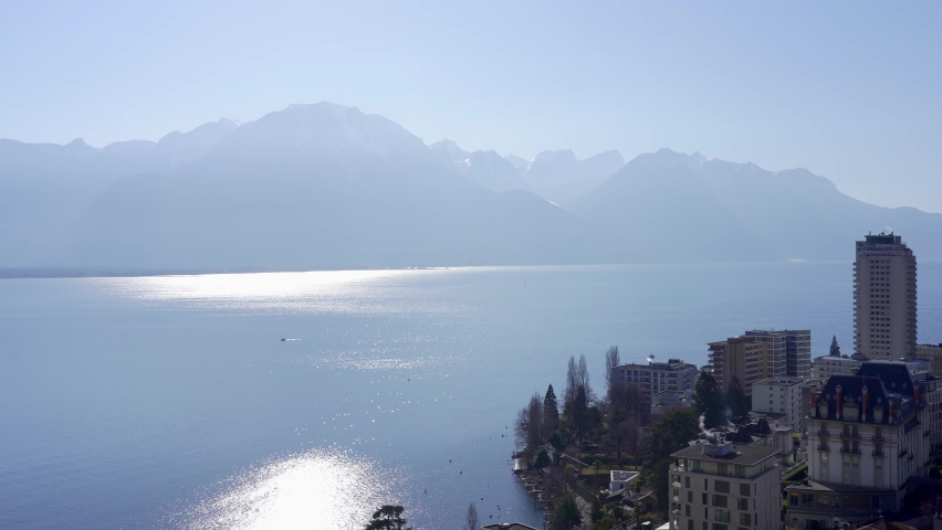 Slow panning view over the Swiss resort town of Montreux with Lake Geneva and the alps in the background. Switzerland