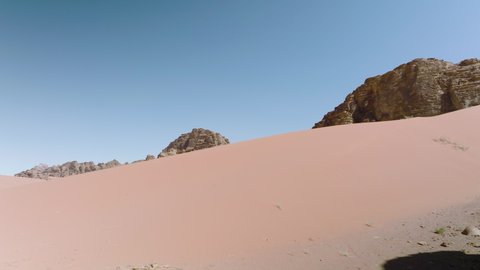 Red Sand Desert With Rock Mountain Formations In Wadi Rum, Jordan. Aerial Sideways