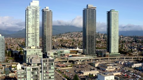 Brentwood Town Centre Station With Four High-rise Architectures With Traffic In The Road In Burnaby, Canada. - aerial