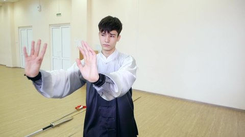 Chelyabinsk, Chelyabinsk region, Russia - 02.06.2022: Guy demonstrates martial arts.

Sharp and smooth movements of the arms and body at the right angle.