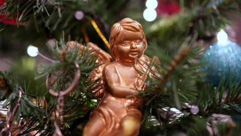 Angel decoration hang at blinking Christmas tree
