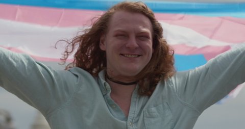 Trans pride - trans woman holds a trans flag