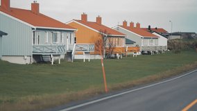 The rural landscape of the Andoya island. Tidy houses and barns stand along the road. Slow-motion, pan backward. - Powered by Shutterstock - Get 15% off with code: PIKWIZARD15