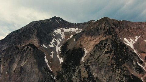 Drone Footage Of Large Alpine Mountain Summit Covered In Melted Snow. Gothic Mountain Colorado USA.