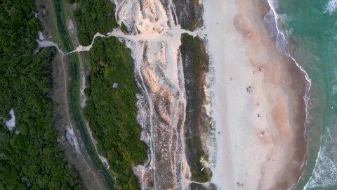 Top Down Aerial Pass Over Golden Sands, Sand Dune and River of Novo Campeche Tropical Brazilian Beach Waves Gently Crashing on Shore With No People Before Sunset Drone 4k
