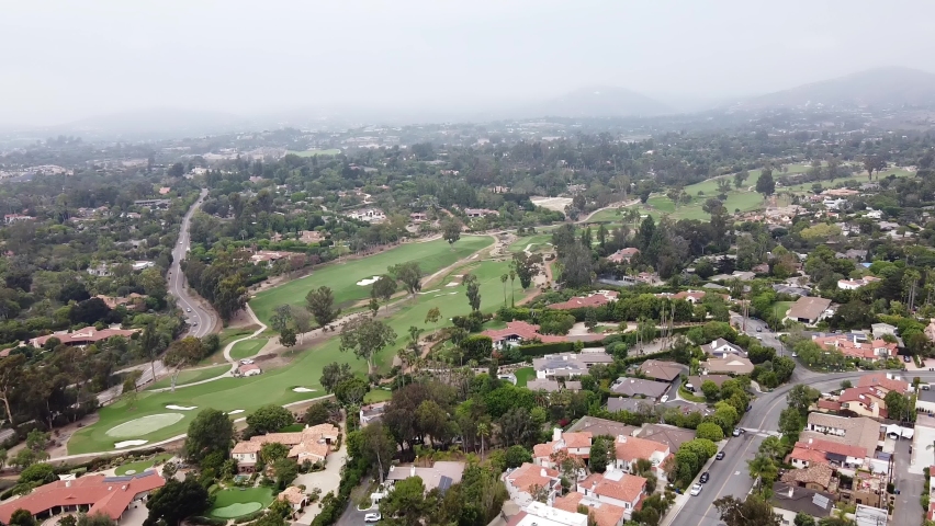 An onward moving aerial shot of Rancho Santa Fe Golf Club course located at Via De La Cumbre, California, United States. It was first opened in 1929 by master golf-course architect Max Behr. Royalty-Free Stock Footage #1089324609