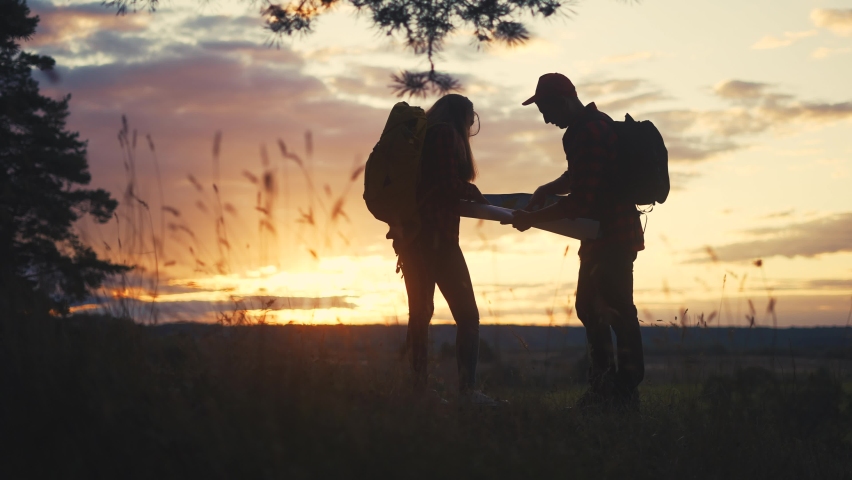 hiker group. team of hikers with backpacks silhouette with map the forest. nature travel a adventure concept. hiker group with backpacks with map on lifestyle the sunset. mountain outdoor view
