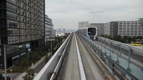 Tokyo, Japan - Apr 23, 22: Train of the Yurikamome line is going to Odaiba. High quality slowmotion footage. Driverless train.