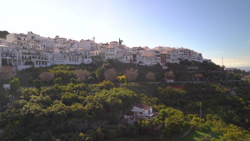 Panoramic pan across typical Spanish valley with white washed village