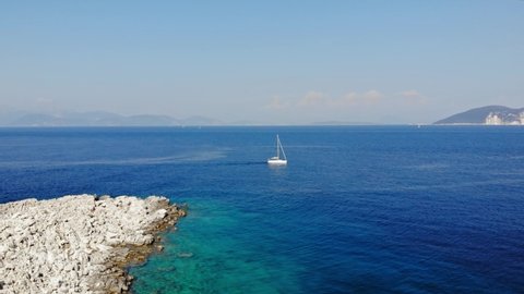 Boats Navigating the Oceans Between The Rocky Shores And Mountain Of Paralia Emplisi, Kefalonia In Greece- Aerial Shot