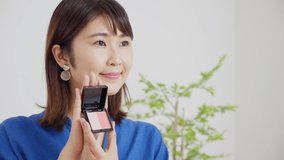 Asian woman distributing video of makeup tools
