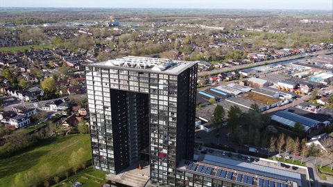 GRONINGEN, NETHERLANDS - 16. APRIL 2022: Ascending Aerial view of Tasman Tower, modern appartment comlex in Groningen.