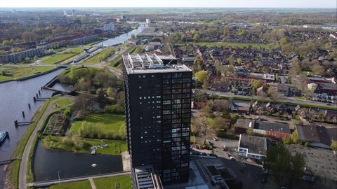 GRONINGEN, NETHERLANDS - 16. APRIL 2022: Orbiting aerial shot of Tasman Tower, modern apartment comlex in Groningen.