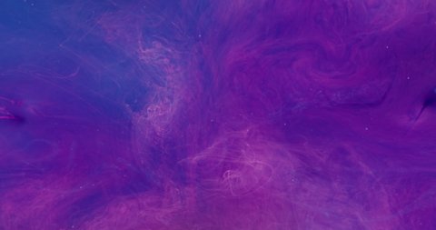 Paint water drop. Color explosion. Transition layer. Neon pink blue ink splash on bright purple smoke cloud abstract background shot on Red Cinema camera 6k.