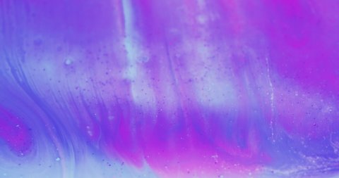 Color fluid mix. Glitter ink wave. Floating paint. Blur iridescent purple pink blue liquid flow motion abstract art background shot on RED Cinema camera.