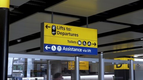 London , United Kingdom (UK) - 03 19 2022: Yellow and blue directional signage at Heathrow International Airport Terminal 3, the sign provides passengers with guidance to the departure terminal, toile