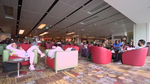 Singapore , Singapore - 04 12 2022: Passengers Sitting On The Chairs Lounge At Changi Airport While Waiting For Their Flight
