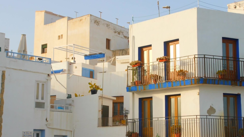 Exterior Of Whitewashed Houses Against Clear Blue Sky On A Sunny Day | Shutterstock HD Video #1089342793