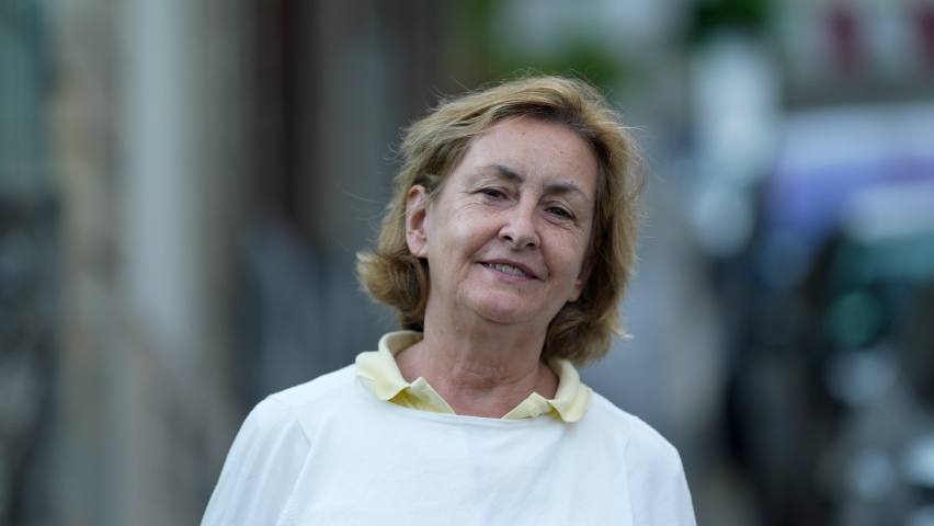 Portrait of a happy older woman smiling at camera funny senior attractive person