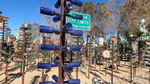 Oro Grande, CA, USA – April 15, 2022: A walking through Elmer’s Bottle Tree Ranch located on historical Route 66 in the Mojave Desert in California.
