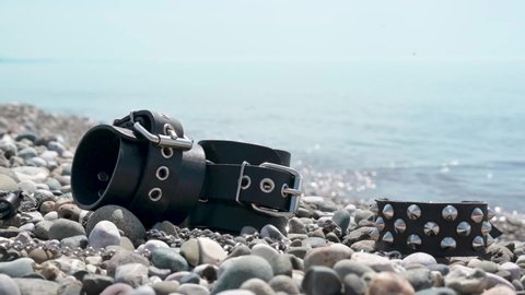 leather handcuffs for bdsm sex toys on the seashore