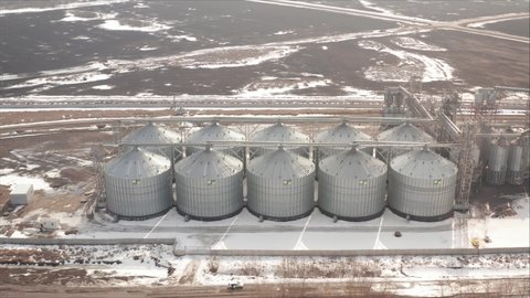 Agricultural Industrial Background. Huge metal grain silos in the heartland. Grain Cooperative. Industrial elevator for grain storage.