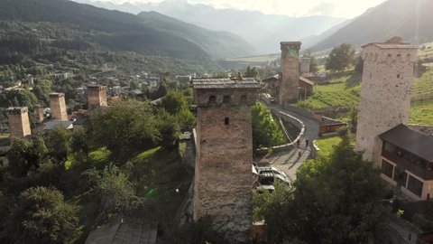 Aerial drone view of the village with traditional Svan towers in Caucasus mountains in Svaneti region of Georgia. Svan towers are historic tower houses built as defensive dwellings in remote location