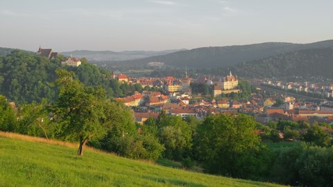 Panorama of the Sighisoara cityscape in summer, Romania. Slow panning of Sigishoara old town. Towers and rooftops of medieval city of Sighishoara in Transylvania, Romania. Birthplace of Vlad Dracula