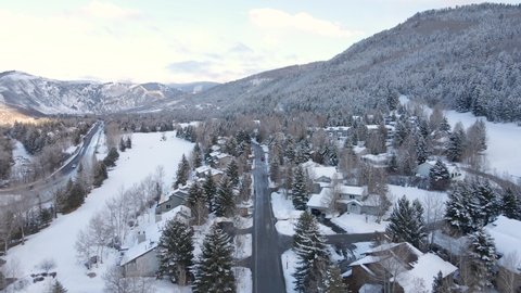 Aerial View of Wet Road and White Winter Landscape of Avon and Beaver Creek Ski Resort, Colorado USA, Drone Shot
