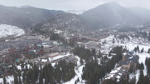 Aerial View of Snowfall Above Keystone Ski Resort, Colorado USA, Buildings and Hills in Winter Season, Drone Shot