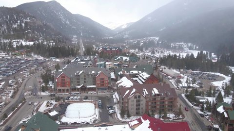 Aerial View of Keystone Ski Resort, Colorado USA, Buildings and Streets Under Ski Tracks in Winter Season, Drone Shot